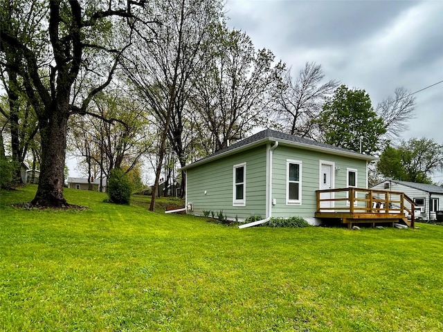 3825 15th St, Des Moines, IA 50313 - view of side of home with a deck and a yard