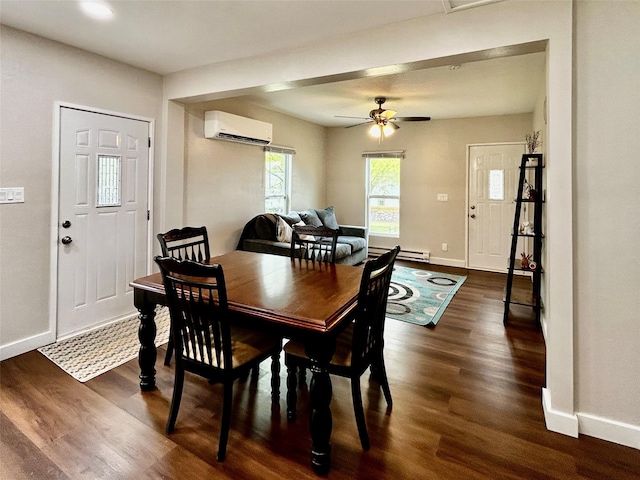 3825 15th St, Des Moines, IA 50313 - dining space featuring a wall mounted air conditioner, baseboards, dark wood finished floors, and a ceiling fan