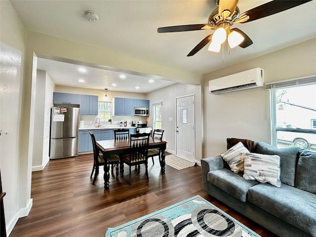 3825 15th St, Des Moines, IA 50313 - living area featuring a wall mounted air conditioner, recessed lighting, dark wood-style flooring, baseboards, and a ceiling fan