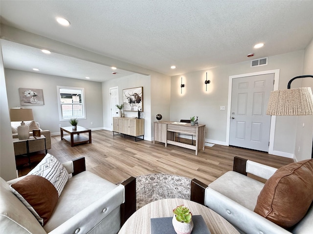 4825 SW 9th St, Des Moines, IA 50315 - living room with wood finished floors, baseboards, recessed lighting, and a textured ceiling