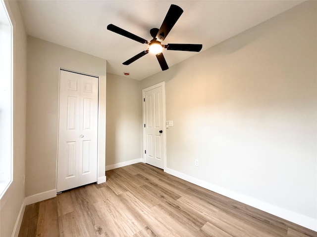 4825 SW 9th St, Des Moines, IA 50315 - unfurnished bedroom featuring wood finished floors, baseboards, a closet, and ceiling fan