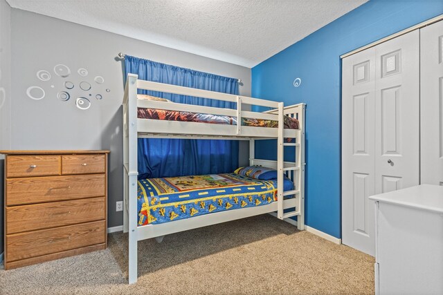 727 SE Richland Ct, Ankeny, IA 50021 - bedroom with carpet, a textured ceiling, a closet, and baseboards