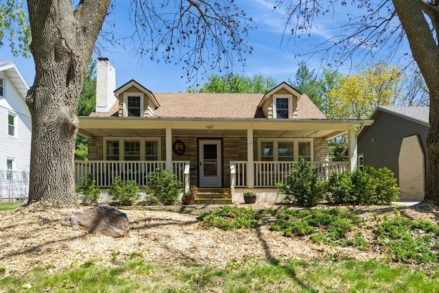 view of front of property with a chimney and covered porch