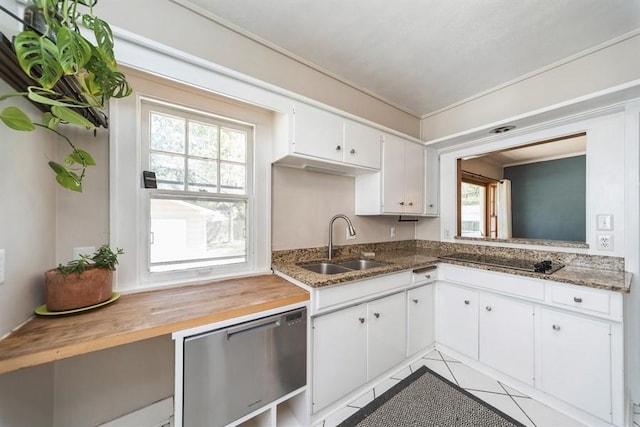 kitchen featuring light tile patterned floors, a wealth of natural light, wooden counters, and a sink