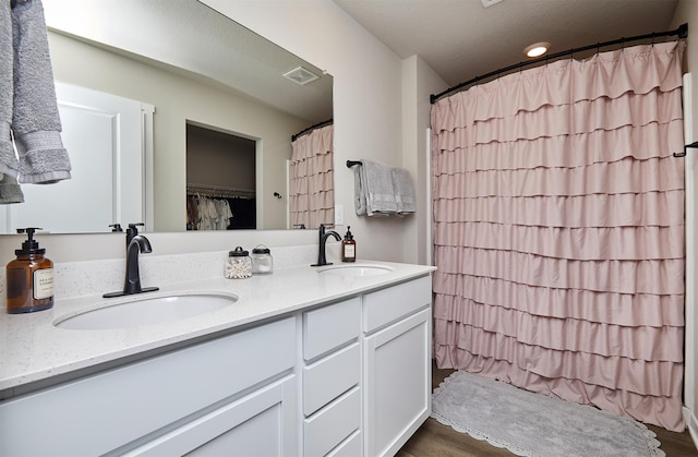1150 NW Williamsburg Ln, Waukee, IA 50263 - full bath featuring double vanity, a shower with shower curtain, and wood finished floors