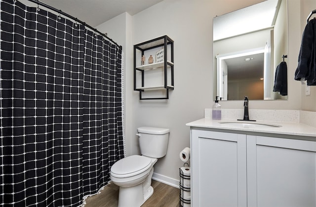 1150 NW Williamsburg Ln, Waukee, IA 50263 - full bathroom with wood finished floors, toilet, vanity, a shower with curtain, and baseboards