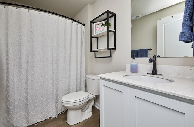 1150 NW Williamsburg Ln, Waukee, IA 50263 - full bathroom featuring toilet, wood finished floors, vanity, and curtained shower