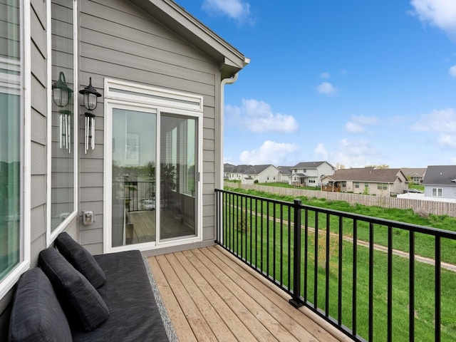 wooden deck with a yard, a residential view, and fence