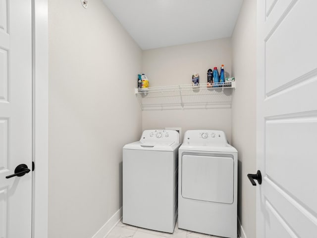 washroom featuring baseboards, marble finish floor, laundry area, and independent washer and dryer