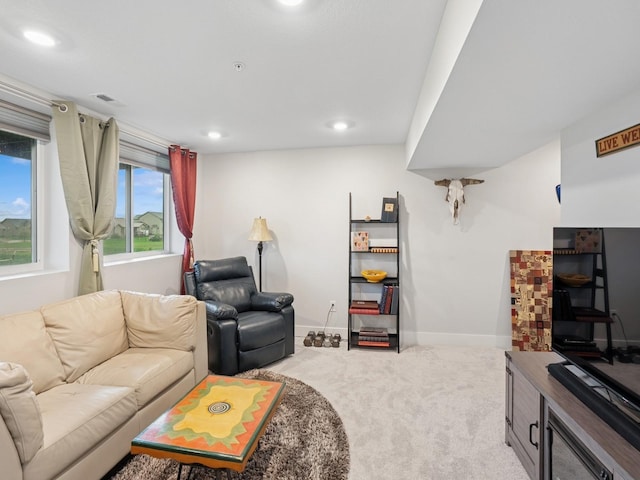 living area featuring carpet floors, baseboards, visible vents, and recessed lighting