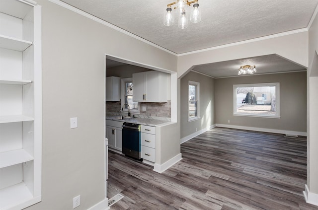 kitchen featuring dishwashing machine, a sink, open shelves, dark wood-type flooring, and ornamental molding