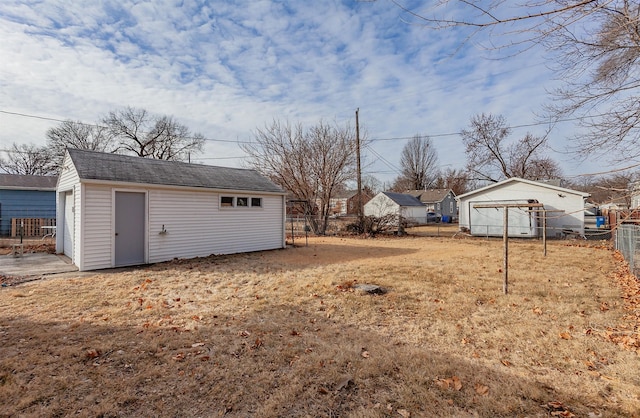 view of yard featuring an outdoor structure and a fenced backyard