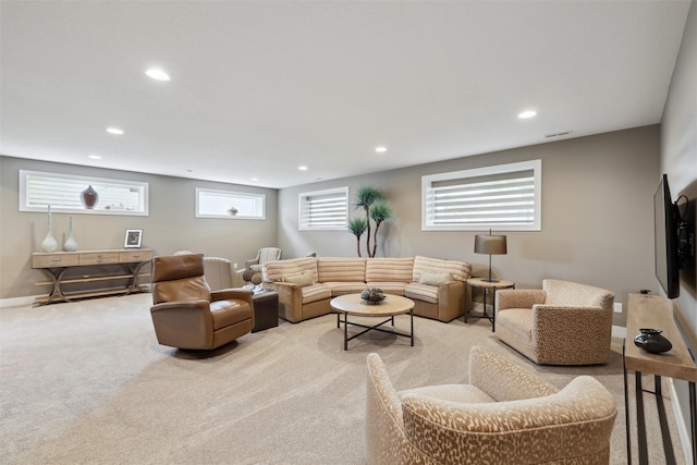 living area featuring light colored carpet, visible vents, baseboards, and recessed lighting