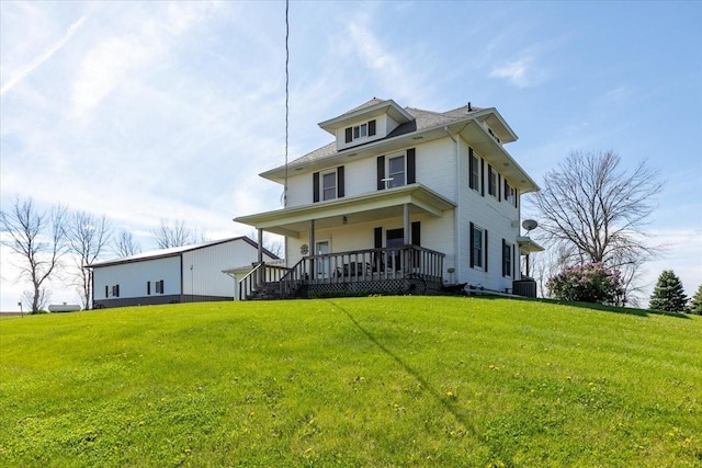 1208 310th Ave, Malcom, IA 50157 - traditional style home featuring covered porch, central air condition unit, and a front lawn