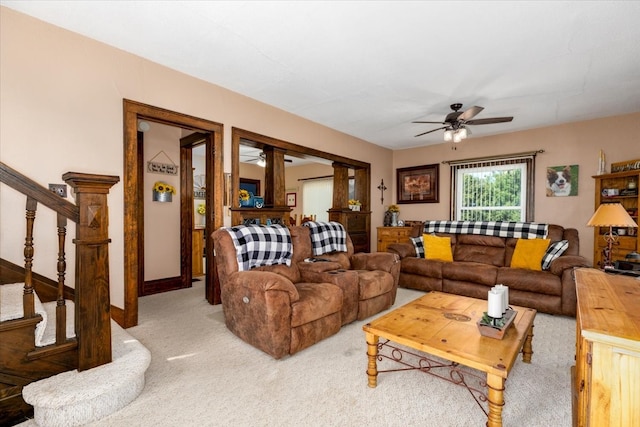1208 310th Ave, Malcom, IA 50157 - living room with a ceiling fan, light carpet, and stairway
