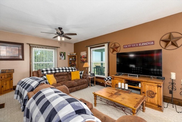 1208 310th Ave, Malcom, IA 50157 - living room with carpet floors, a ceiling fan, and baseboards