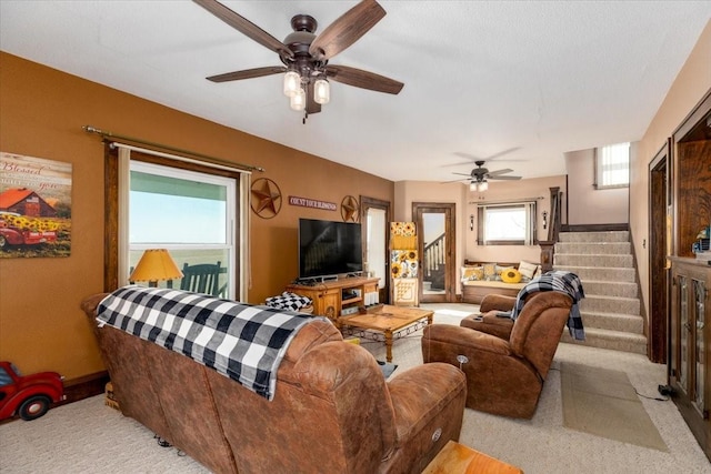 1208 310th Ave, Malcom, IA 50157 - living room featuring carpet flooring, stairway, and a ceiling fan