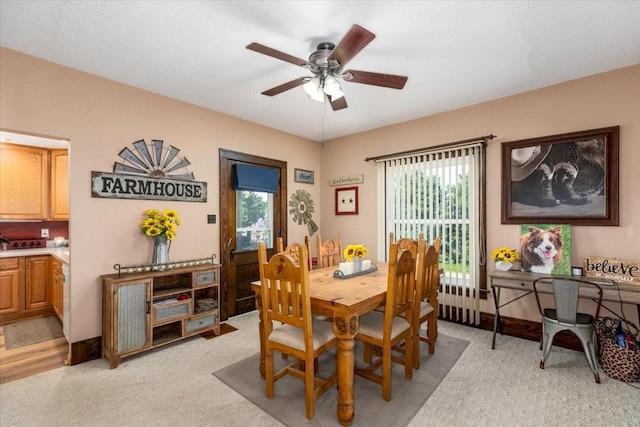 1208 310th Ave, Malcom, IA 50157 - dining space featuring light carpet and a ceiling fan