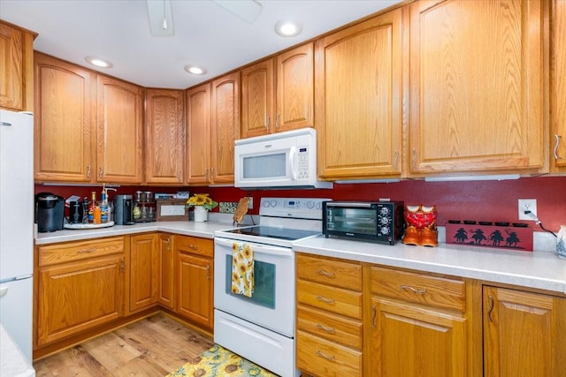 1208 310th Ave, Malcom, IA 50157 - kitchen with a toaster, brown cabinetry, white appliances, light countertops, and light wood-style floors