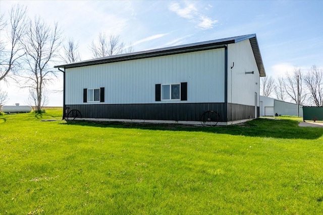 1208 310th Ave, Malcom, IA 50157 - view of property exterior with a garage, an outbuilding, and a lawn