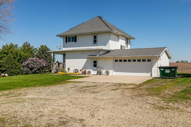 1208 310th Ave, Malcom, IA 50157 - back of property with dirt driveway, a yard, and a garage