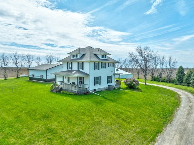 1208 310th Ave, Malcom, IA 50157 - rear view of house with a lawn, central AC, and a wooden deck