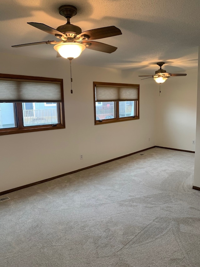 6750 School St Unit 1016, Windsor Heights, IA 50324 - empty room with a ceiling fan, light carpet, visible vents, and baseboards