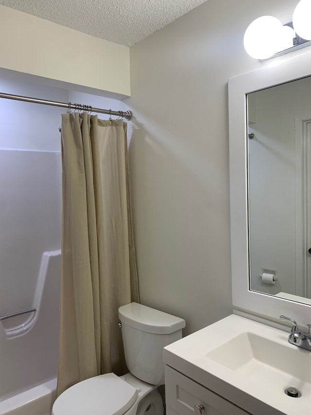 6750 School St Unit 1016, Windsor Heights, IA 50324 - bathroom featuring vanity, a textured ceiling, curtained shower, and toilet
