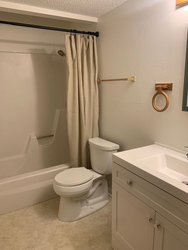 6750 School St Unit 1016, Windsor Heights, IA 50324 - bathroom featuring toilet, shower / tub combo with curtain, vanity, and a textured ceiling
