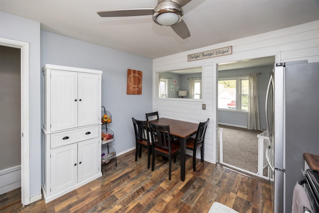 dining room with dark wood-type flooring, baseboards, and a ceiling fan