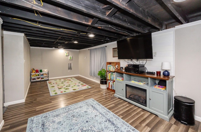 finished below grade area featuring baseboards and wood finished floors