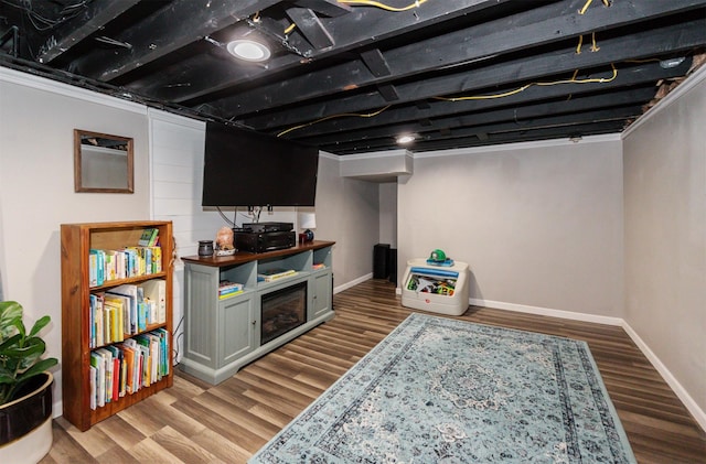 finished basement with baseboards and wood finished floors