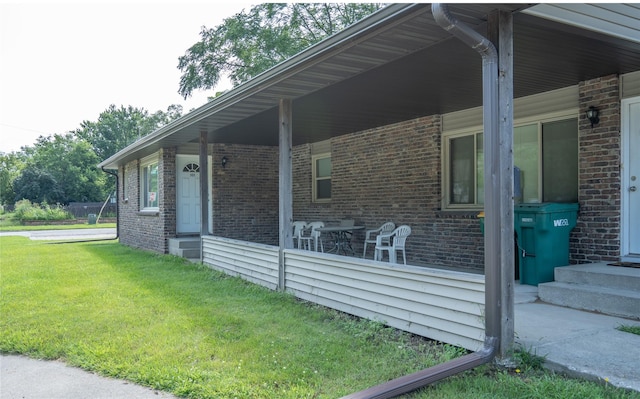 view of home's exterior featuring a yard, entry steps, and brick siding