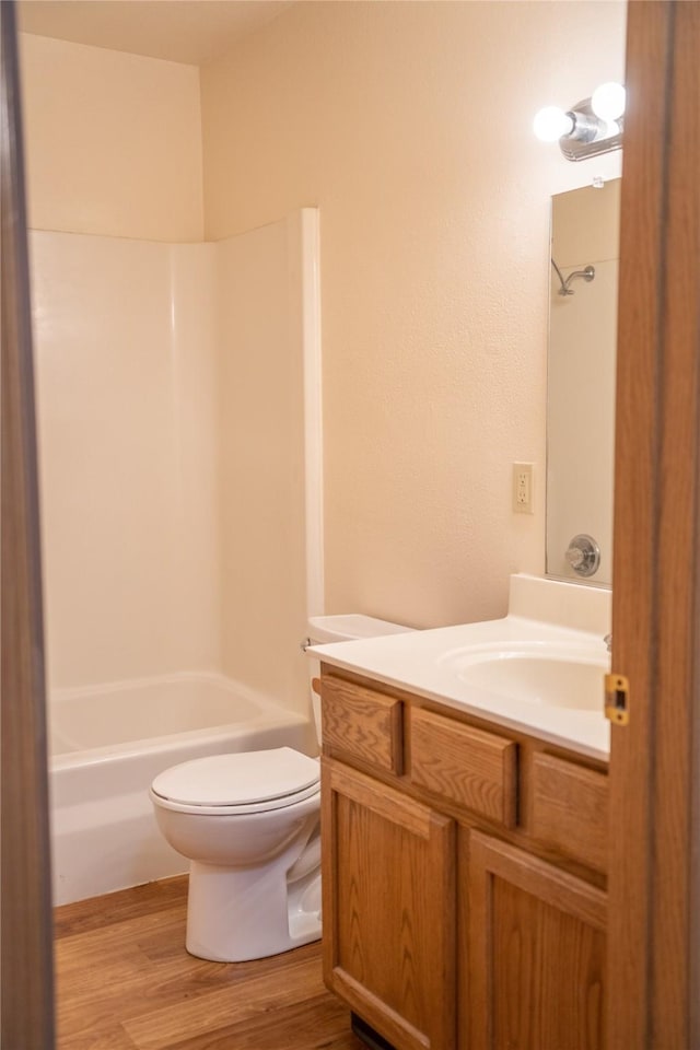 full bath featuring vanity, toilet, shower / bathtub combination, and wood finished floors