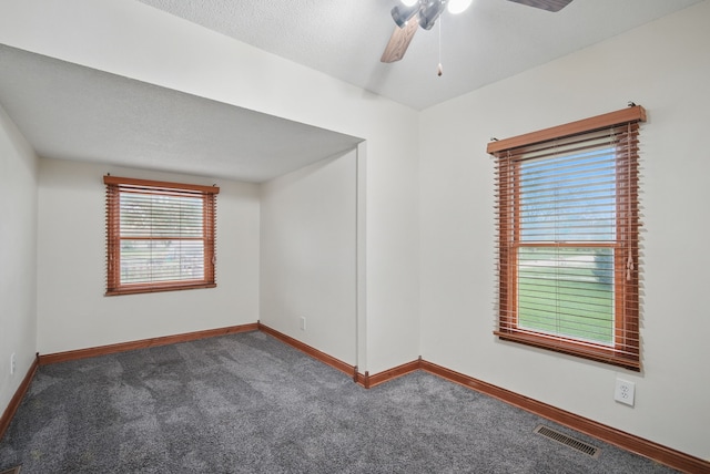 unfurnished room with ceiling fan, carpet, baseboards, and visible vents