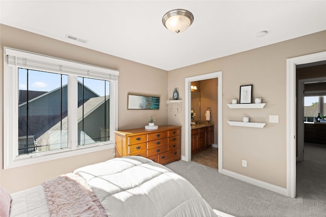 bedroom featuring light carpet, baseboards, visible vents, and multiple windows