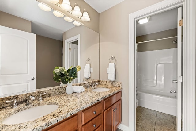 full bath with a sink, double vanity, shower / bath combination, and tile patterned floors