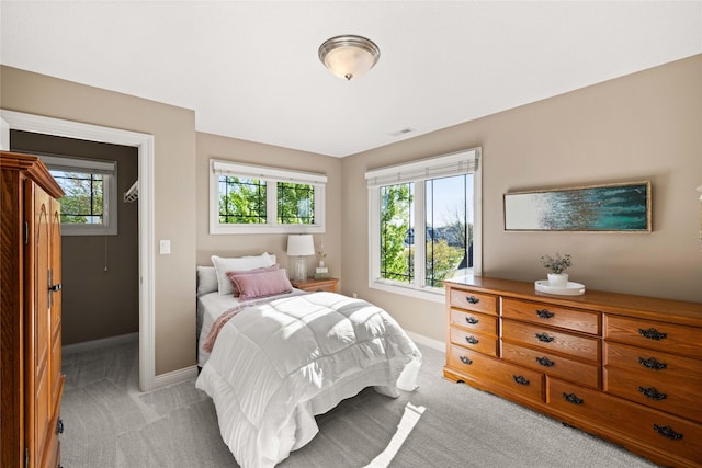 bedroom with light colored carpet, baseboards, and visible vents