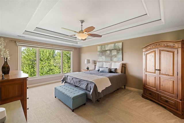 bedroom with light colored carpet, a raised ceiling, and crown molding
