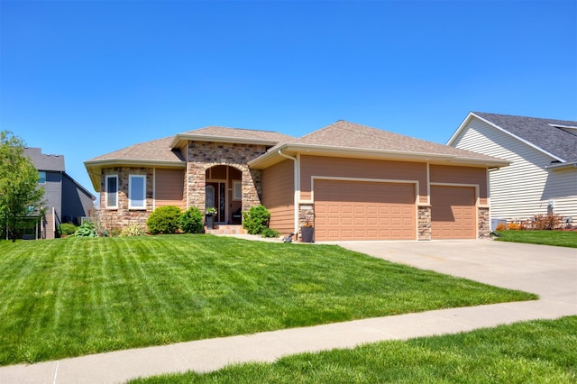 4110 140th St, Urbandale, IA 50323 - view of front facade featuring concrete driveway, a front yard, a garage, and stone siding