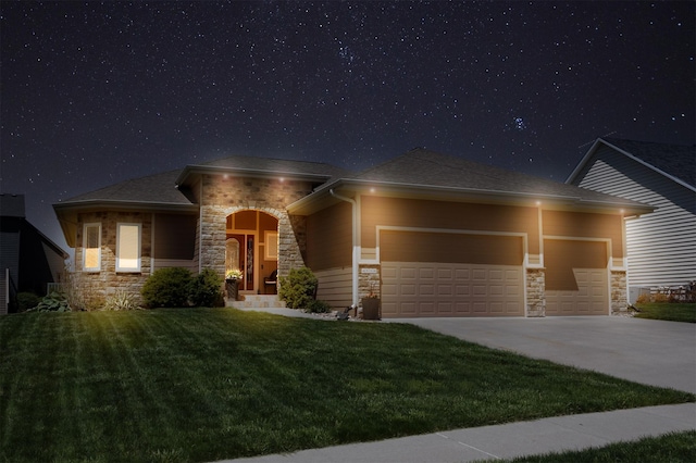 4110 140th St, Urbandale, IA 50323 - prairie-style home featuring concrete driveway, stone siding, a garage, and a lawn