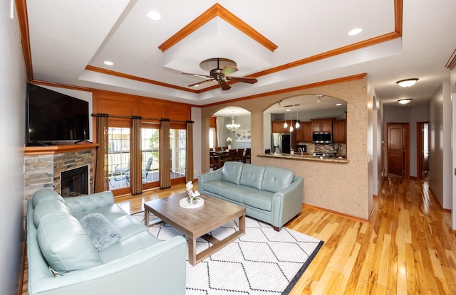 4110 140th St, Urbandale, IA 50323 - living area with light wood-style flooring, a raised ceiling, ceiling fan, arched walkways, and ornamental molding