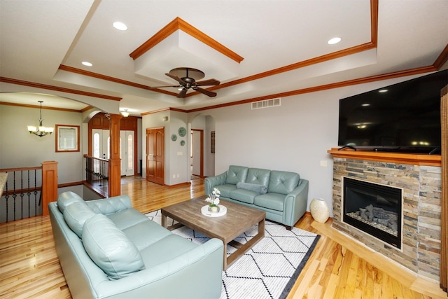 4110 140th St, Urbandale, IA 50323 - living room with a tray ceiling, ornamental molding, arched walkways, and visible vents