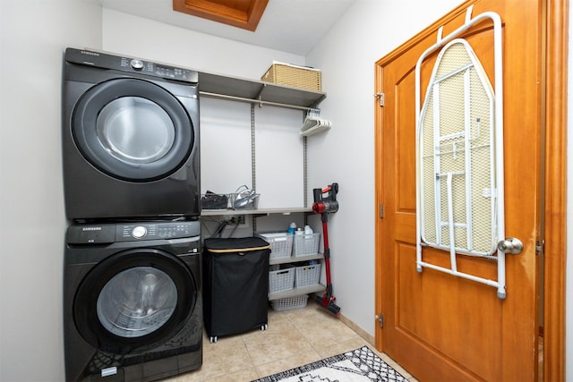 4110 140th St, Urbandale, IA 50323 - laundry room with baseboards, tile patterned floors, laundry area, and stacked washer and clothes dryer