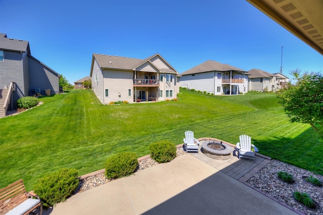 4110 140th St, Urbandale, IA 50323 - rear view of house featuring a yard, a patio, a fire pit, and a balcony