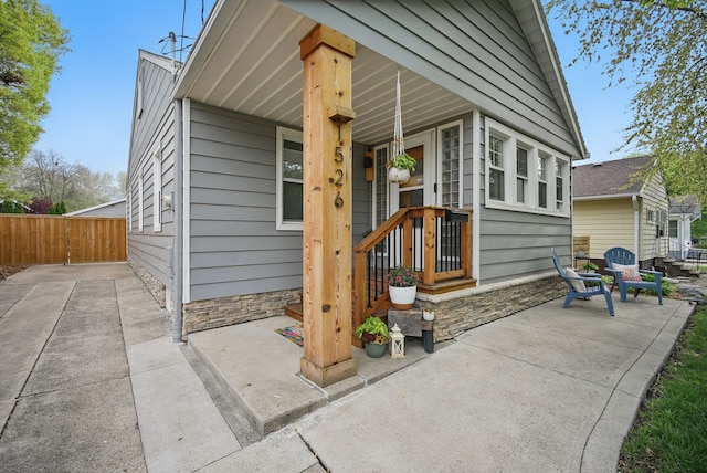 view of front of house with fence and stone siding