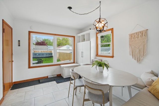 dining area featuring a chandelier, light tile patterned flooring, a wealth of natural light, and visible vents