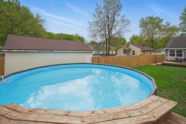 view of swimming pool featuring a fenced backyard, a deck, and a fenced in pool