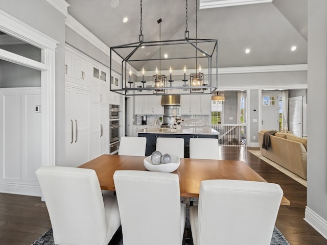 dining area with recessed lighting, a chandelier, crown molding, and dark wood-type flooring