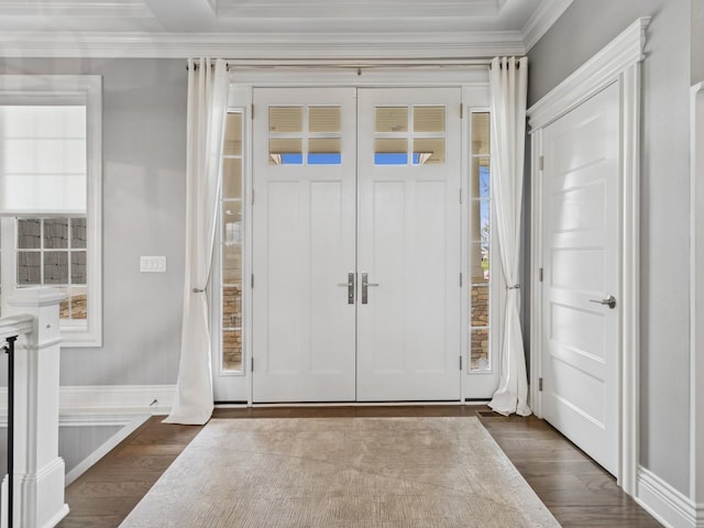 entryway featuring ornamental molding, baseboards, and dark wood finished floors